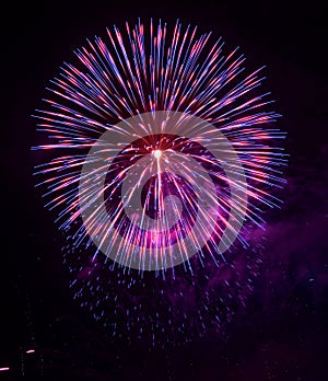 Colorful different colors, amazing fireworks in Malta, dark sky background and house light in the far, Independence day, fireworks