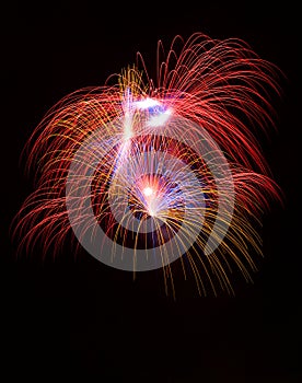 Colorful different colors, amazing fireworks in Malta, dark sky background and house light in the far, Independence day, fireworks