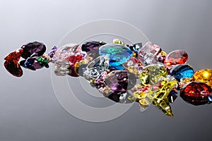 Colorful of different gemstones with space for text on gray back