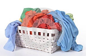 Colorful dirty clothes in laundry basket