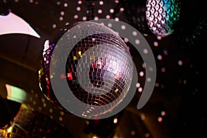 Colorful disco mirror ball lights night club background.