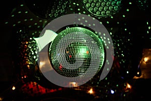 Colorful disco mirror ball lights night club background.