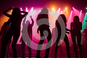 Colorful disco party scene with black silhouettes of people dancing against a vibrant neon-lit background with disco balls and