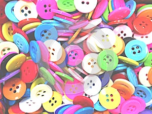 Colorful disorderly sewing buttons background with soft light