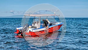 A colorful dive boat being prepared to take tourists on a scuba dive.