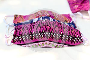 Colorful DIY fabric cotton protective masks on white background.