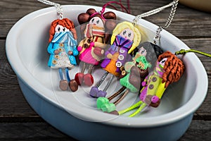 Colorful dolls in a small ceramic ramekin photo