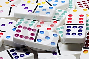 Colorful dominoes in a pile on a table