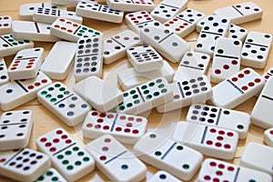 Colorful Dominoes Spread Out on Wooden Floor