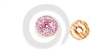 Colorful donut isolated on white.  Sweet icing sugar food with glazed sprinkles, doughnut with frosting. Top view with copy space