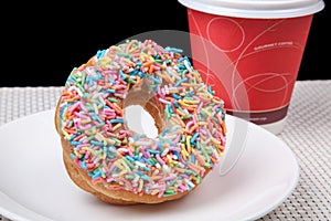 Colorful Donut in white plate and coffee with black background