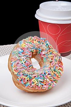 Colorful Donut in white plate and coffee with black background