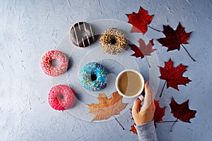 Colorful donuts with a Cup of coffee