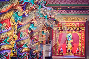 Colorful dragons and statue of Nezha, the protective deity in Ch