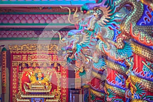 Colorful dragons and statue of Nezha, the protective deity in Ch