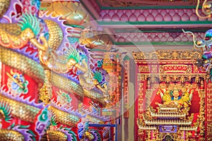 Colorful dragons and statue of Nezha, the protective deity in Ch