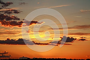 Colorful dramatic sunset on sky with bizarre clouds