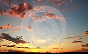 Colorful dramatic sunset on sky with bizarre clouds