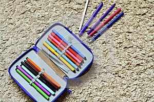 Colorful drawing pencils and open epmty  notebook