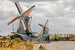 Colorful Dutch Windmills at the river Zaan, Zaanse Schans, Zaandam