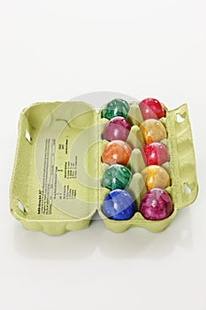 Colorful, dyed Easter eggs in carton