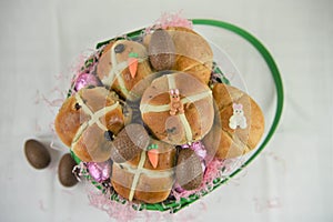 Easter breakfast with fresh hot cross buns and croissants with decorations