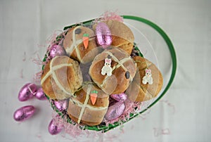 Easter breakfast with fresh hot cross buns and croissants with decorations