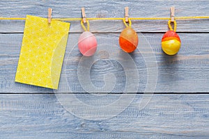 Colorful easter card and garland on wood background