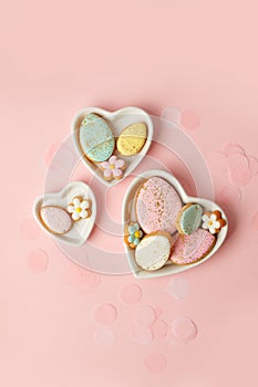 Colorful easter cookies with icing on pink background, colorful seasonal holiday concept, stylish greeting card, invitation, flyer