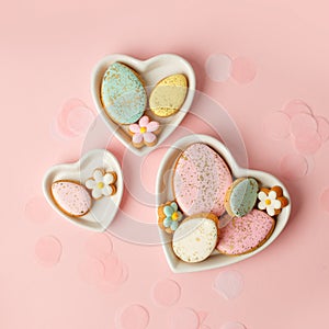 Colorful easter cookies with icing on pink background, colorful seasonal holiday concept, stylish greeting card, invitation, flyer