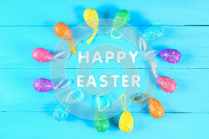 Colorful easter egg on blue pastel color wood background with space. Happy easter.