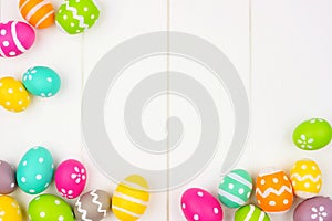 Colorful Easter Egg frame or corner border over a white wood background