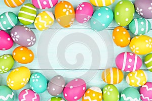 Colorful Easter Egg frame over a soft blue wood background