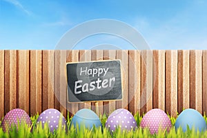 Colorful easter egg with Happy easter greeting on black sign boa