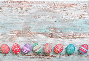 Colorful Easter egg side border against a rustic wood Vintage pa