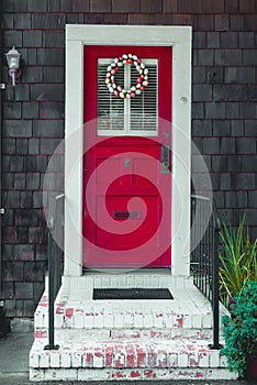 Colorful easter egg wreath on a front red door.