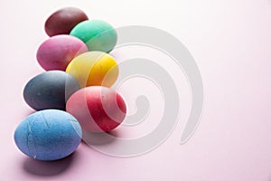 Colorful Easter eggs as an attribute of Easter celebration. Pink background