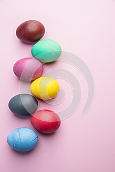 Colorful Easter eggs as an attribute of Easter celebration. Pink background