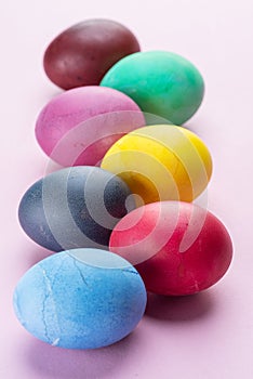 Colorful Easter eggs as an attribute of Easter celebration. Pink background