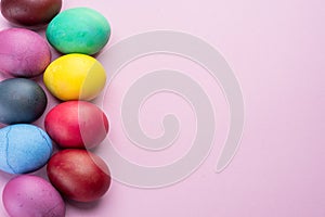 Colorful Easter eggs as an attribute of Easter celebration. Pink background