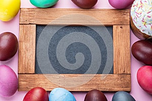 Colorful Easter eggs as an attribute of Easter celebration. Pink background