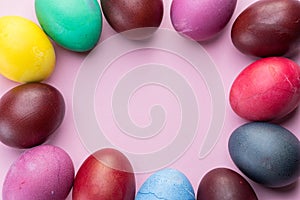 Colorful Easter eggs as an attribute of Easter celebration. Pink background