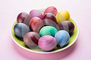 Colorful Easter eggs as an attribute of Easter celebration. Pink background