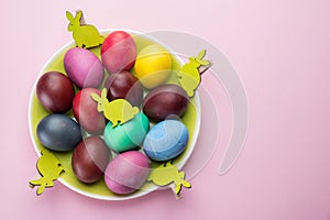 Colorful Easter eggs as an attribute of Easter celebration. Pink background