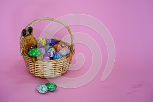 The colorful Easter eggs in the basker pink background