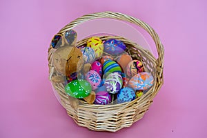 The colorful Easter eggs in the basker pink background