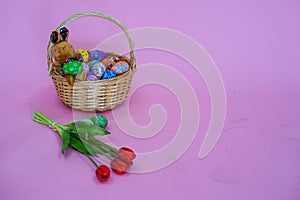 The colorful Easter eggs in the basker pink background