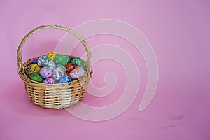 The colorful Easter eggs in the basker pink background