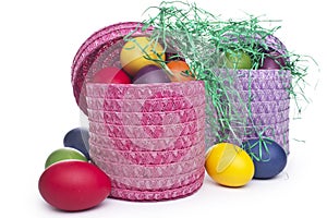 Colorful Easter eggs in a basket on the gras