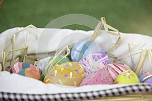 Colorful Easter eggs in the basket on green grass at the yard   festival and holiday spring coming  Easter calibration